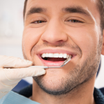 Young man at dentist - diseases your dentist can detect