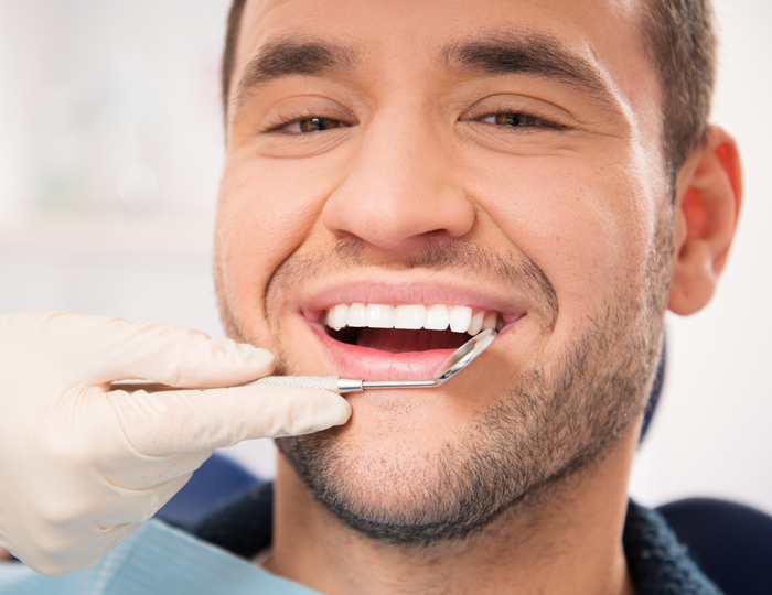Young man at dentist - diseases your dentist can detect