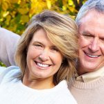 couple enjoying their cosmetic dentistry with smiles