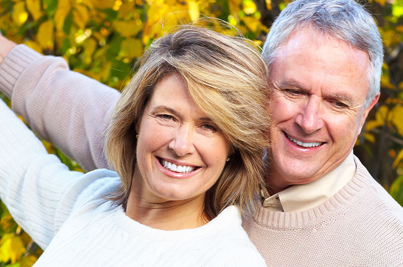 couple enjoying their cosmetic dentistry with smiles